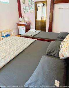 two bunk beds in a room with a mirror at Mai Anh Homestay Long Hải in Long Hai