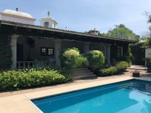 a house with a swimming pool in front of a house at Casa La Bonita in Cuernavaca