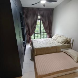 a bedroom with two beds and a window at Farhah Homestay Selayang Kuala Lumpur - malay only in Batu Caves +21 photos