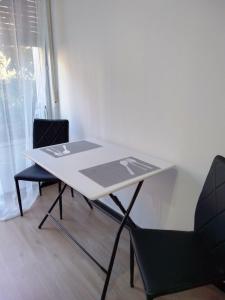 a white table and chairs in a room at Red_Cross.Rent_Appartament in Palermo