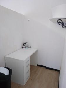 an office with a white desk and a black chair at Red_Cross.Rent_Appartament in Palermo