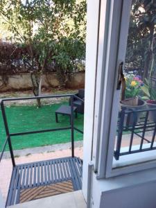 an open door with a bench on a porch at Red_Cross.Rent_Appartament in Palermo