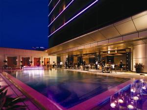 a building with a swimming pool at night at Sands Macao in Macau