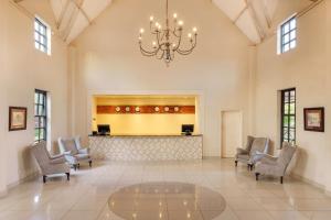 a large lobby with chairs and a chandelier at Protea Hotel by Marriott Chingola in Chingola +48 photos