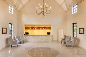 a large lobby with chairs and a chandelier at Protea Hotel by Marriott Chingola in Chingola