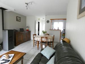 a living room with a couch and a table at Maison de plain-pied avec cour privée, proche de la plage, idéale pour familles, Côte d'Opale. - FR-1-376-108 in Hesdigneul-lès-Boulogne