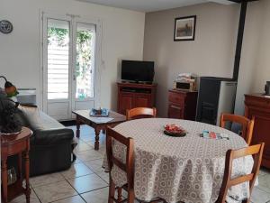 a living room with a table and a couch at Maison de plain-pied avec cour privée, proche de la plage, idéale pour familles, Côte d'Opale. - FR-1-376-108 in Hesdigneul-lès-Boulogne