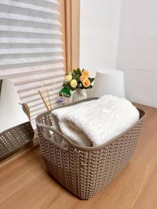 a basket sitting on a floor with a vase of flowers at [OPEN SALE] wide room #hotel bedding #Full option in Seoul