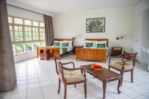 a living room with a couch and a table at Yatu Lau Lagoon Resort Fiji in Pacific Harbour