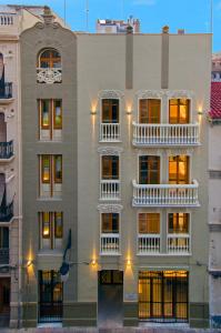 a building with white balconies on the side of it at Zalamera BnB in Valencia