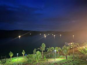 a night view of a body of water with street lights at Dak Nguyen Homestay & Farm 3 in Gia Nghĩa