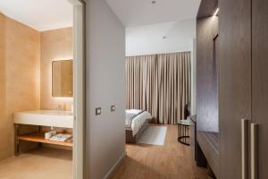 a hotel room with a bed and a sink at Troci Hotel in Tirana
