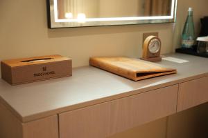 a counter with a box and a clock on it at Troci Hotel in Tirana