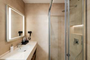 a bathroom with a sink and a shower at Troci Hotel in Tirana