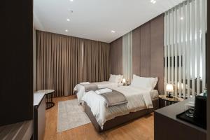 a bedroom with two beds and a television at Troci Hotel in Tirana