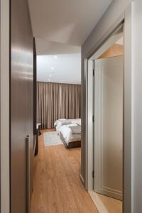 a bedroom with a bed and an open door at Troci Hotel in Tirana