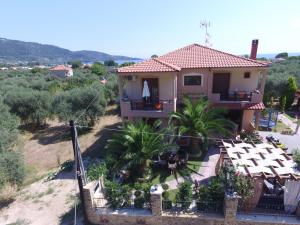 a house with a balcony and a yard at Summer Dreams Studios in Skala Potamias