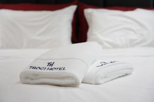 a couple of towels sitting on top of a bed at Troci Hotel in Tirana