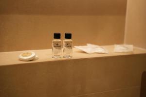 two bottles ofodorizers sitting on top of a counter at Troci Hotel in Tirana