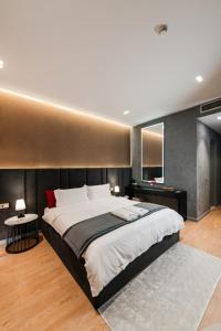 a large bedroom with a large bed and two tables at Troci Hotel in Tirana