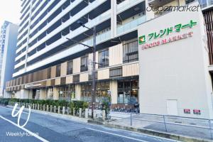 a building with a sign on the side of a street at WeeklyHouse Silto Crete - Vacation STAY 14148v in Otsu