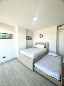 a bedroom with two beds in a room at Departamento al pie del mar - Punta Blanca in Punta Blanca