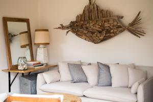 a living room with a white couch and a mirror at Jujube in Dromana +27 photos