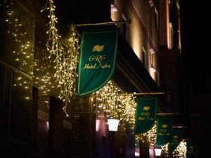 a sign for a cafe next to a building with lights at GRG Hotel Naha in Naha