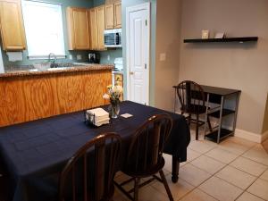 a kitchen with a table with a blue table cloth on it at Long Term Retreat Haven in Chapel Hill