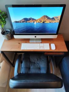 a computer monitor sitting on top of a desk at Oslo Grunerløkka Private Room in Oslo