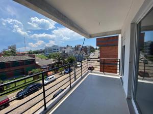 a balcony with a view of a city street at Ótimo Ap a 50m da areia Churrasq 2Q 2banheiros in Torres