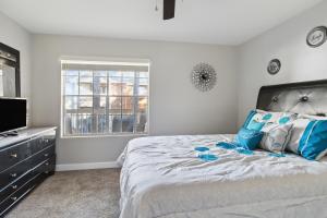 a bedroom with a large bed and a television at Center City Charm, the place to meet all of your needs in Huntsville