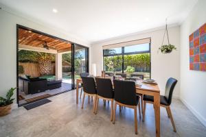 a dining room with a table and chairs at Marble at South Plympton - 4BR Modern WiFi in South Plympton