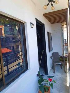 a room with a window and a chair on a balcony at Casa familiar cerca a la estación del metro in Medellín