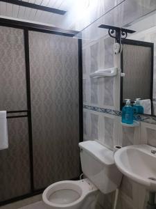 a bathroom with a toilet and a sink at Casa familiar cerca a la estación del metro in Medellín