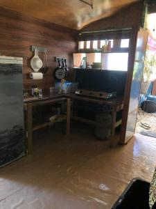 a kitchen with a wooden desk with a stove at FARE Tatahi in Parea