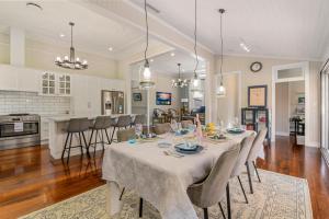 a dining room with a table and a kitchen at Unique Character Queenslander Home! Just Minutes to CBD & South Brisbane in Brisbane