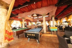 a restaurant with a pool table and a bar at Menada Apartments in Karolina in Sunny Beach