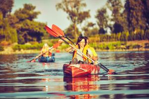 two people are kayaking on the water on a lake at Homestead harmony room with private entrance in Hemet