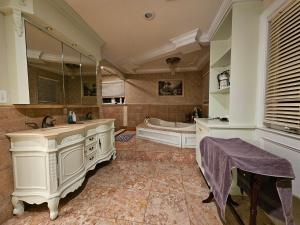 baño grande con bañera, lavabo y tubermott en A cozy shared house with a friendly vibe, en Metuchen