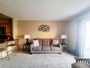 a living room with a couch and two lamps at Amazing 2 Bedroom 2 Bath Condo in Elkins Park