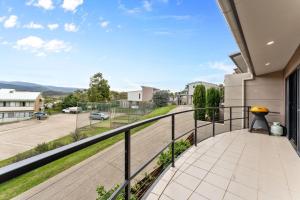 a balcony with a view of a street at Khione 1 Modern spacious with views towards Lake Jindabyne the mountains beyond in Jindabyne