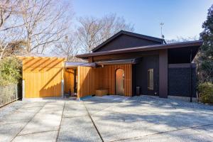 a house with a large driveway in front of it at 源泉かけ流し 白濁 Forest Suite Hakone Sengokuhara in Sengokuhara