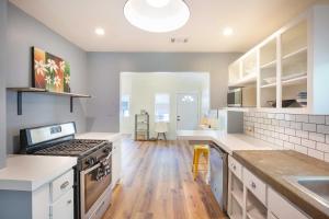 a kitchen with white counters and a stove top oven at Authentic ATX Dtwn Beauty - Pool, Fenced Yard, Walk 2 Best Eateries & BBQ in Austin