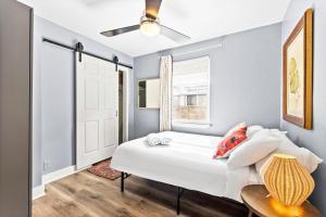 a bedroom with a white bed and a window at Authentic ATX Dtwn Beauty - Pool, Fenced Yard, Walk 2 Best Eateries & BBQ in Austin