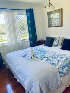 a bedroom with two beds and a window at lavender cottage three large bedroom house in Mount Tamborine