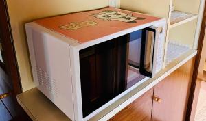 a microwave oven sitting on top of a cabinet at 三木屋Mikiya 名古屋駅徒步约600m 独栋别墅120平 3卧室5床2浴室2卫生间 24小时便利店 in Nagoya