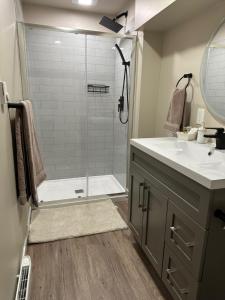 a bathroom with a shower and a sink at Entire Basement Guest Suite In Cranbrook in Cranbrook