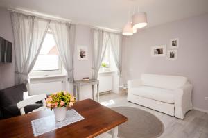 a living room with a white couch and a table at Bärengasse Apartments in Freinsheim