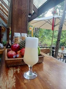 a drink sitting on a table with a basket of fruit at Green Valley Veal Pouch in Kampot